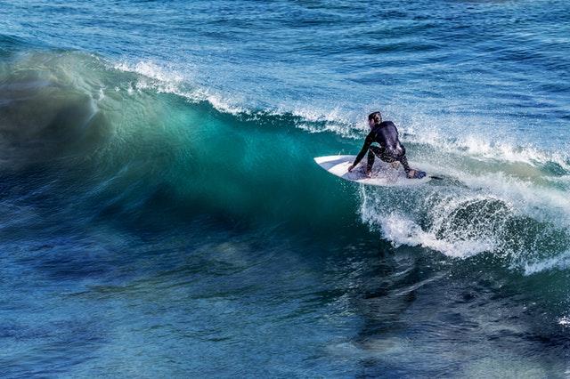 man surfing on surfboard in the ocean